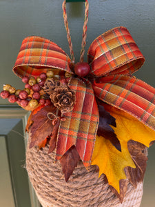 Close Up View of Fall Red, Orange and Yellow Plaid Ribbon with Pinecones, Leaves and Berries