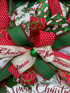 Close Up of Bow Featuring Red Ribbon with White Polka Dots, Merry Christmas in Red on White Ribbon, Green Ribbon with Red Edge , Mistletoe on White Ribbon, Green and White Swirls on Red Ribbon with a small green ball with red and white polka dots. 