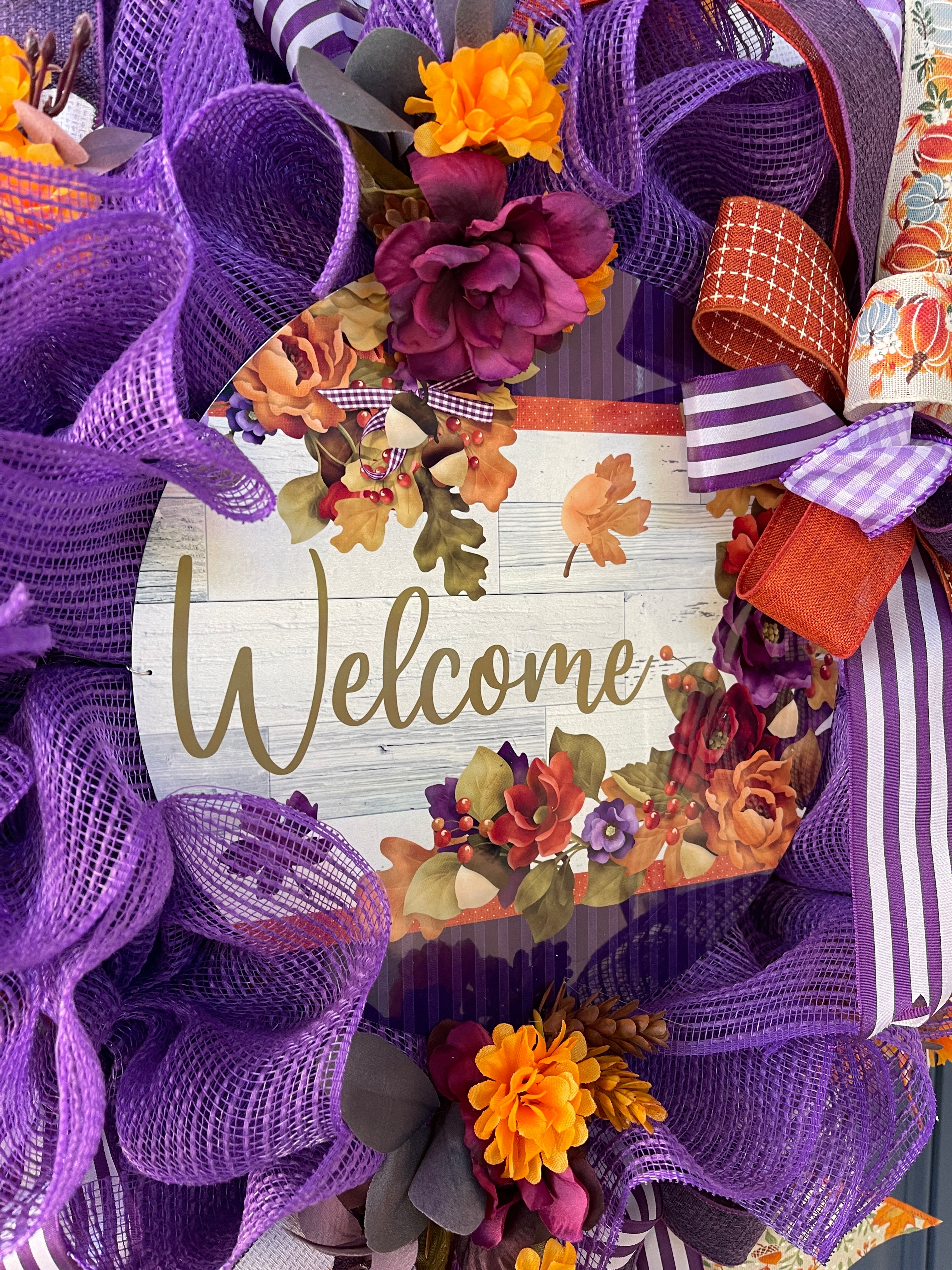 Fall Welcome Sign with Simulated White Wood Background and Featuring Red, Orange, Green, Purple  and Yellow Leaves and Florals i