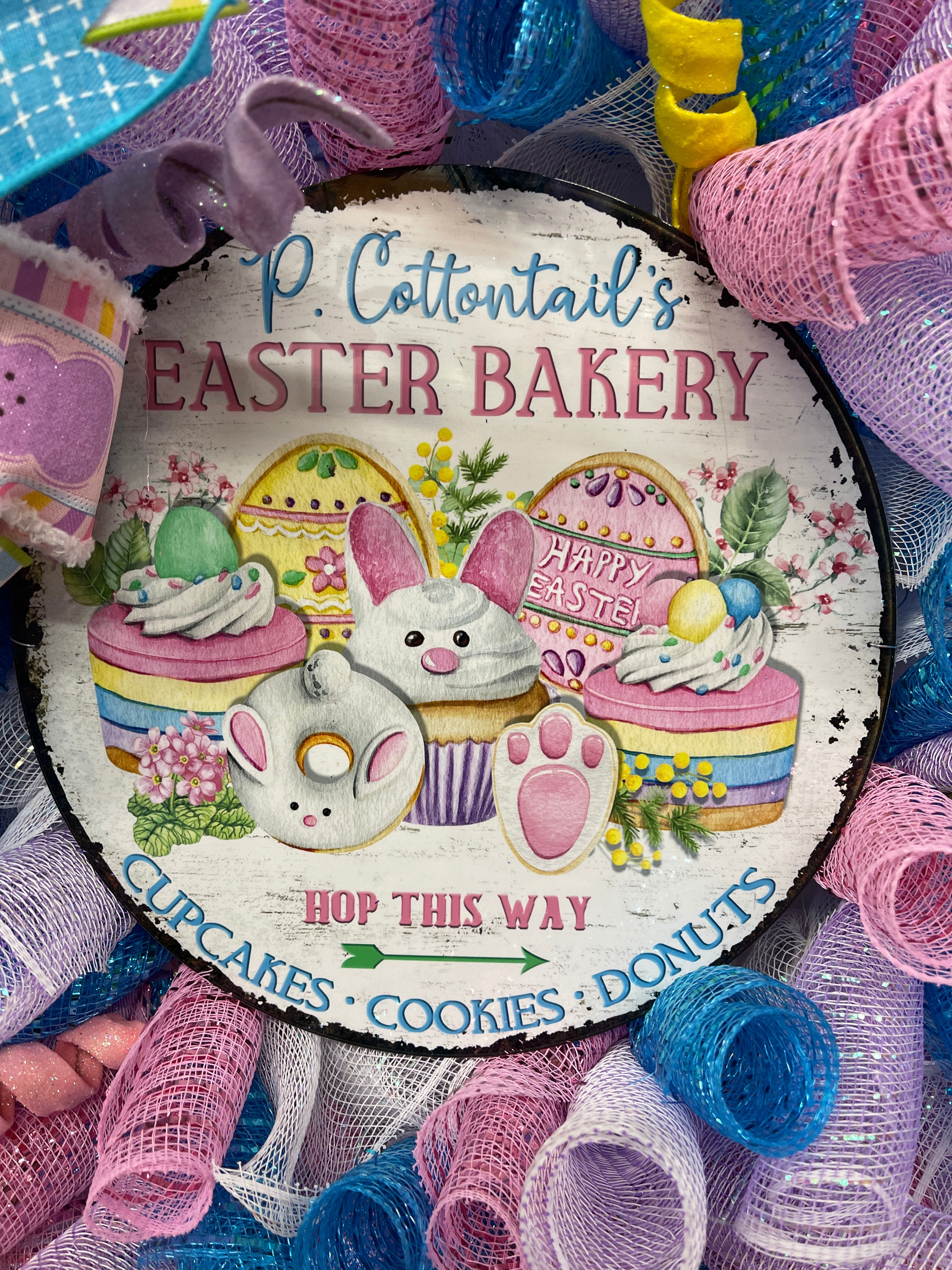 Close Up on P. Cottontails' Easter Bakery Sign, featuring Hop This Way arrow, Cupcakes, Cookies and Donuts