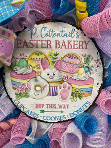 Close Up on P. Cottontails' Easter Bakery Sign, featuring Hop This Way arrow, Cupcakes, Cookies and Donuts