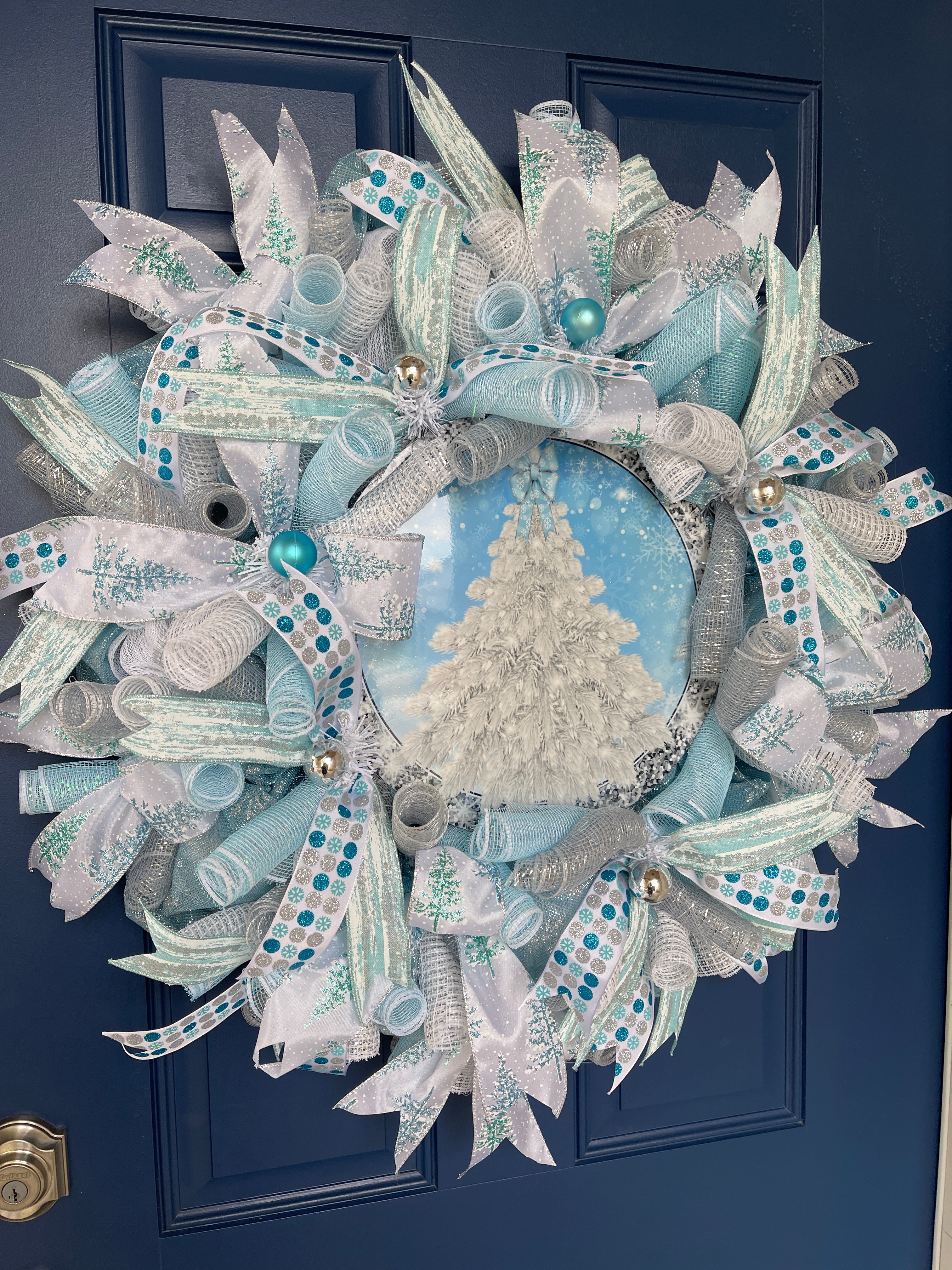 Left Side View of Blue and White Deco Mesh Winter Christmas Tree Wreath on a Blue Door 