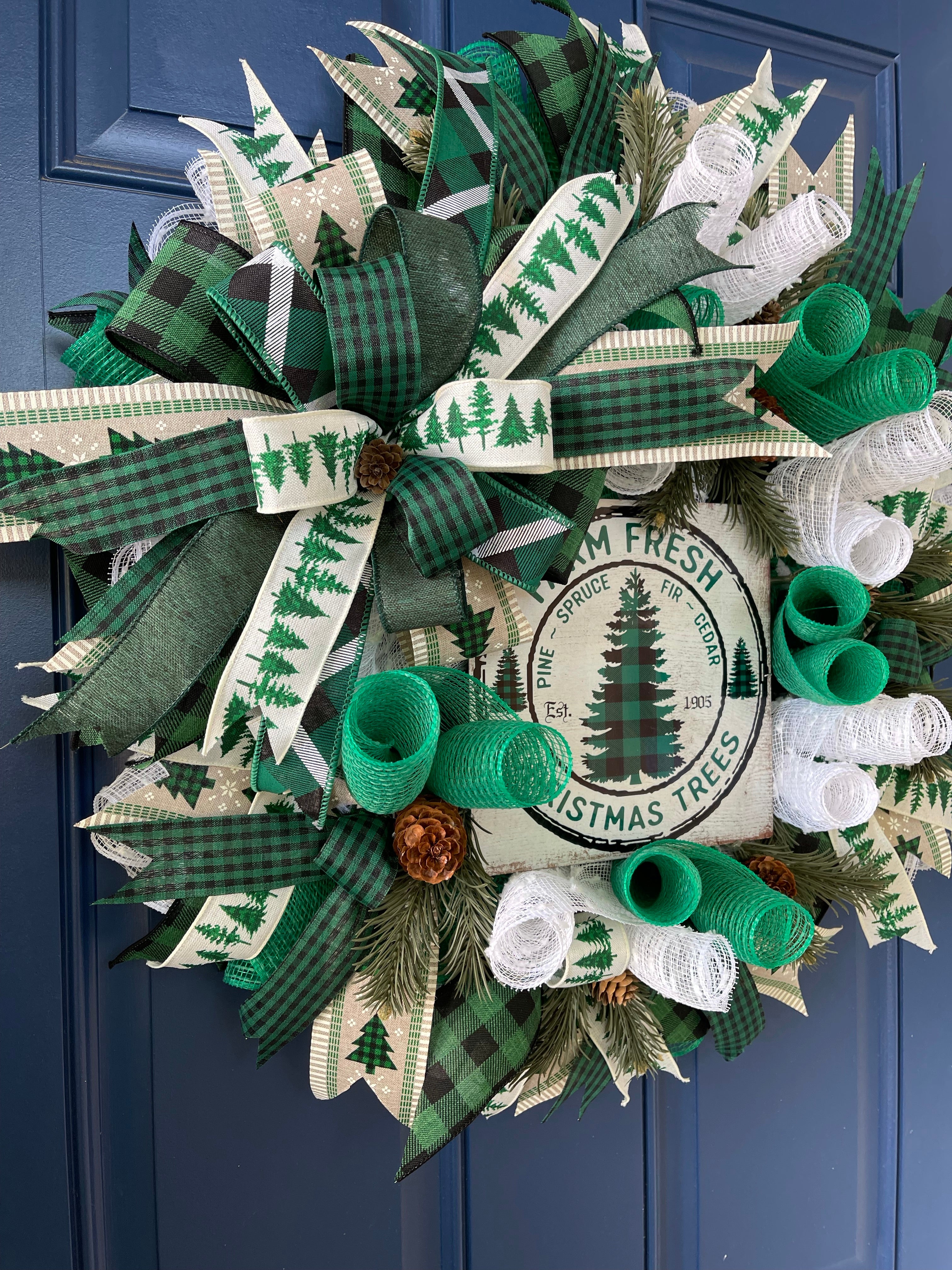 Left Side View of White, Green and Black Deco Mesh Farm Fresh Christmas Wreath on a blue door. 
