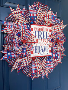 Left Side View of Red, White and Blue Stars and Stripes Storm Door Land of the Free Because of the Brave Wreath on a Blue Door