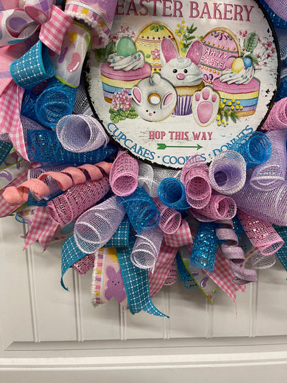 Close up on pastel Deco Mesh Curls of Pink, Blue, White and Purple on an Easter Bakery Wreath