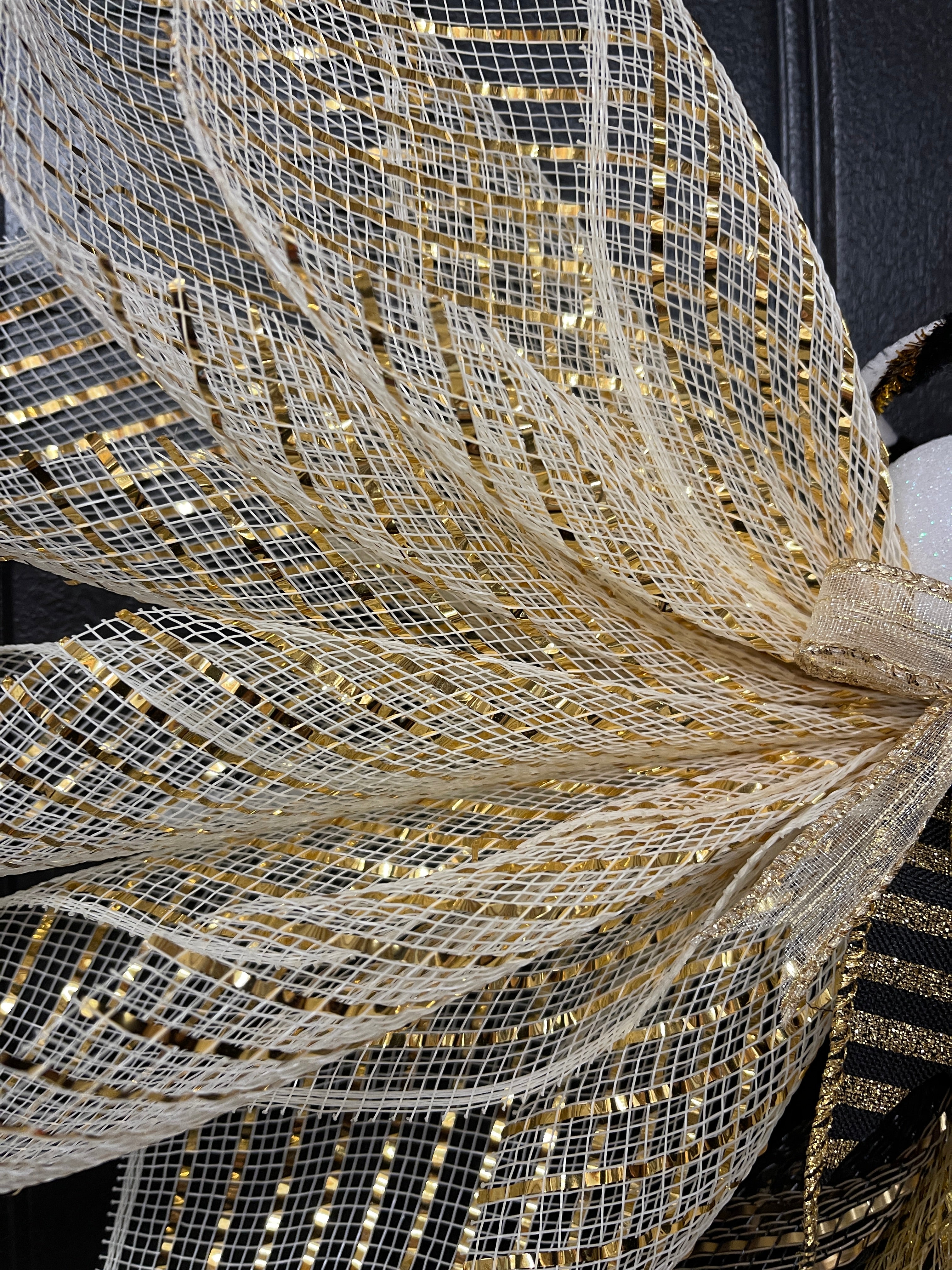 Gold and Black Deco Mesh New Years Angel for Front Door Close Up on Metallic Wings