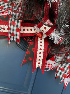 Close Up Detail of Red Ribbon with White Lace and Red Hearts along with a Glittered Red Heart in the Center, paired with a Black Ribbon with Red Hearts