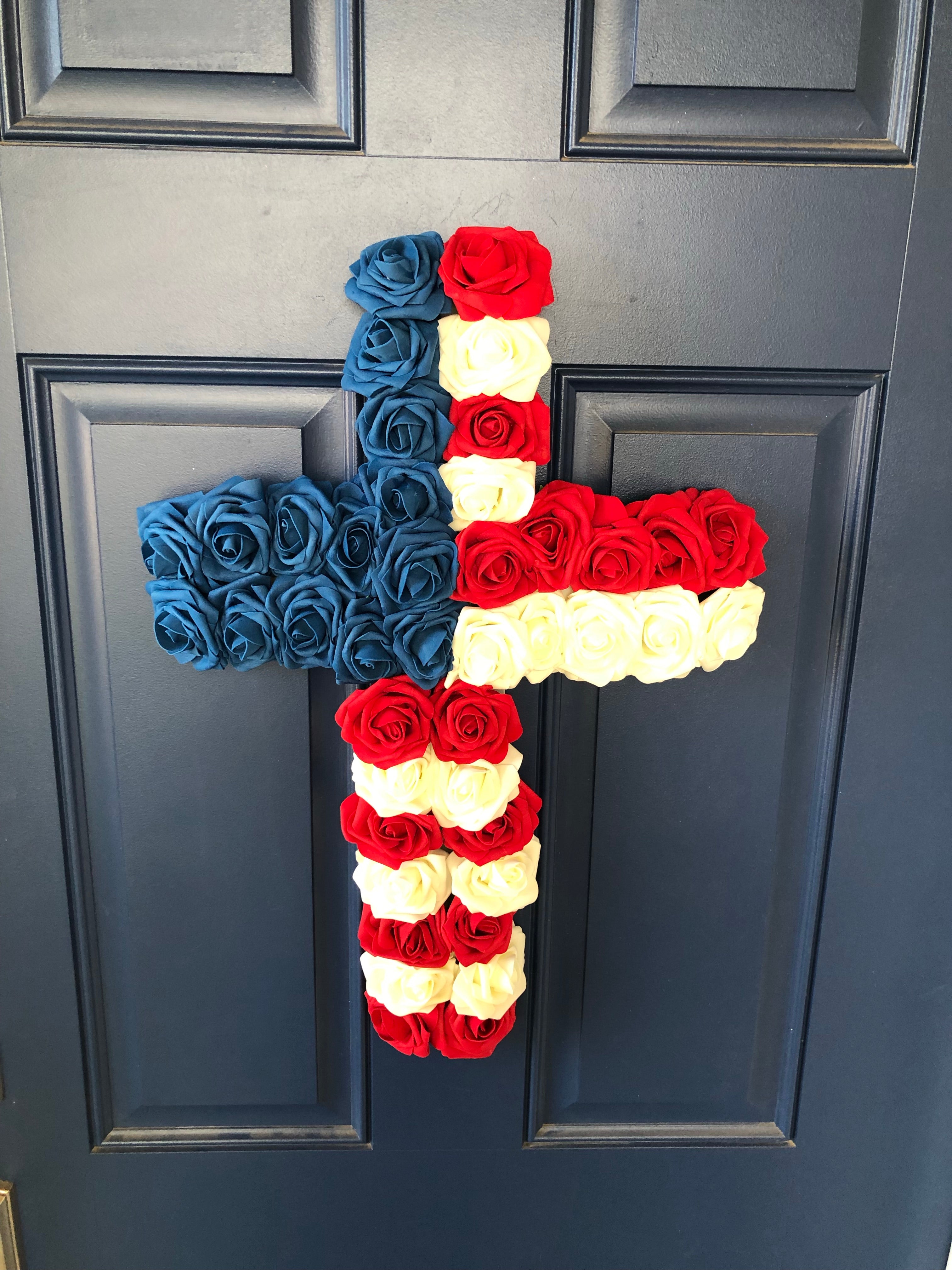 Top View of Red, White and Blue Roses in the shape of a cross on a blue door
