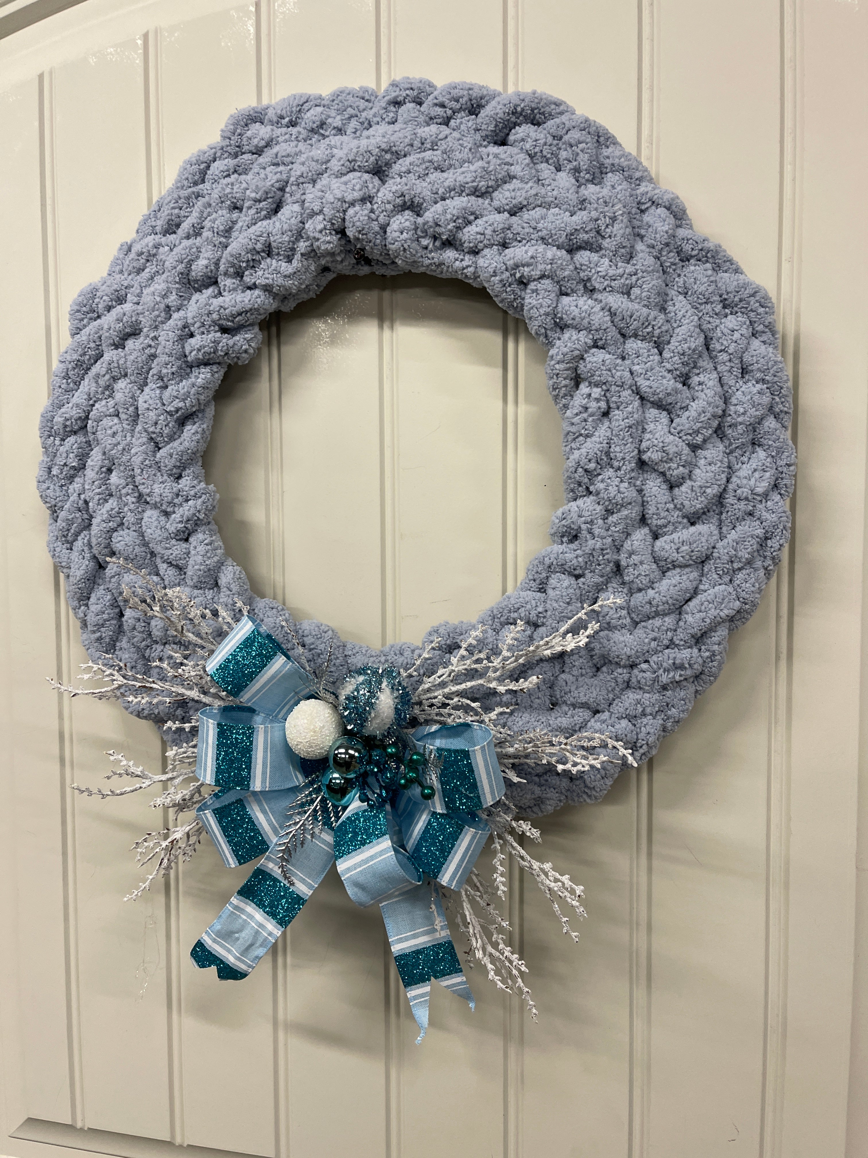 Right Side View of Blue Gray Chenille Yarn Braided Winter Wreath on a White Door