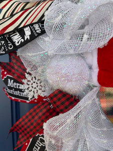 Close Up Detail of Tinsel Iridescent Snowball in White Deco Mesh with Snowflakes, Red and Black Gingham Ribbon, Black, Red and White Diagonal Striped Ribbon, Christmas Words in White on Black Ribbon and Merry Christmas on Black with red Polka Dots Ribbon