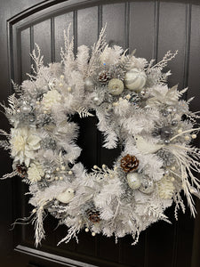 Right Side View of White Evergreen Winter Wreath with White Poinsettias, Frosted Pine Cones, Christmas Balls of Silver, White and Gray, along with Silver Glittered Fern and Snow Covered Twigs and 2 White Doves on a Black Door