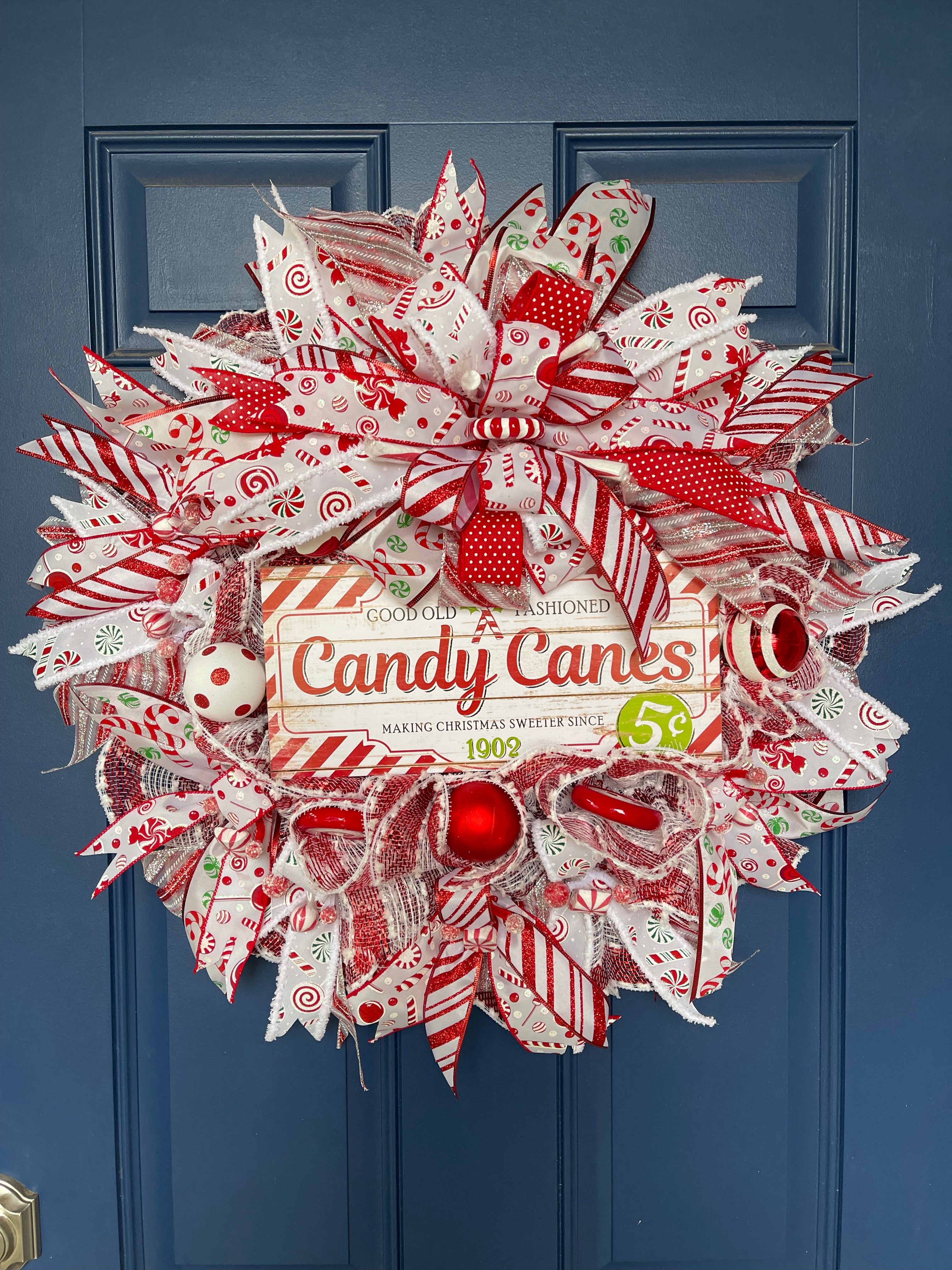 "Old Fashioned Candy Canes" candy cane and peppermint themed Christmas wreath hanging on door 