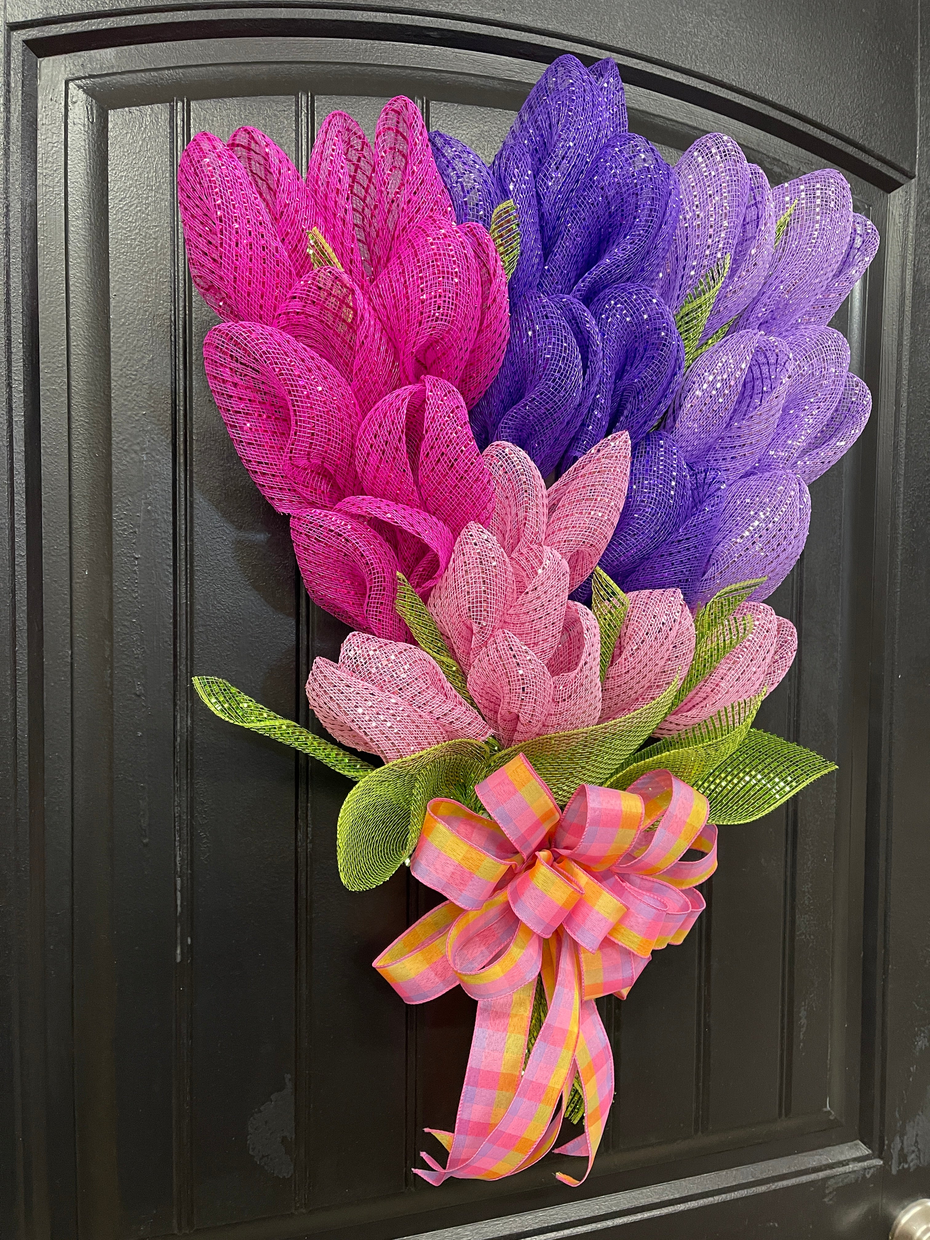 Left Side View of Fuchsia, Lavender, Purple and Pink Deco Mesh Tulip Bouquet Wreath on a Black Door with a Pink, Purple and Yellow Plaid Bow