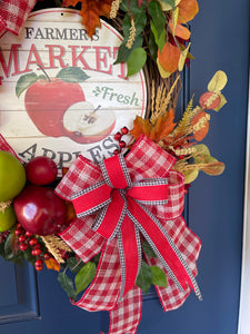Close up of Lower Bow of Red, White and Black Ribbons, Fall Leaves, Red and Green small and large apples with Farmers Market Fresh Apple Metal Sign on Grapevine Wreath