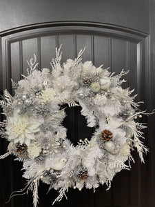 White Evergreen Winter Wreath with White Poinsettias, Frosted Pine Cones, Christmas Balls of Silver, White and Gray, along with Silver Glittered Fern and Snow Covered Twigs and 2 White Doves on a Black Door