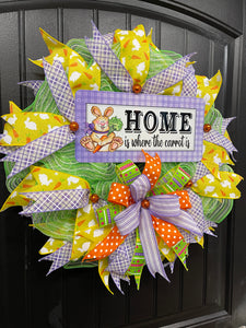Left Side View of Home is Where the Carrot Is Easter Bunny Wreath with Yellow, Purple, Green, Orange and White Ribbons and Bow on a Black Door