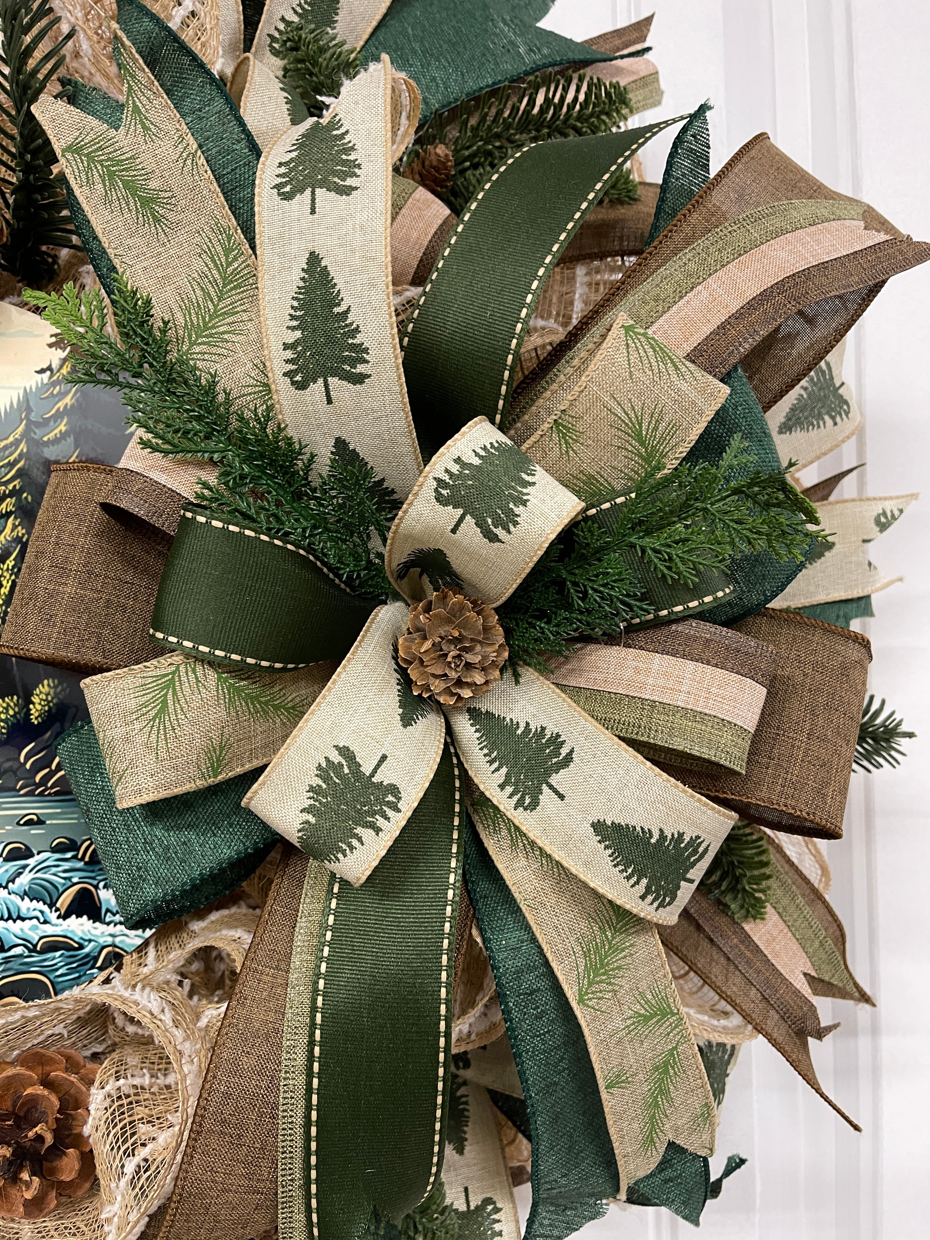 Close Up Detail of Bow with Pinecones, Pine Sprigs, and Ribbons with Pine Trees, and Pine Branches, along with Brown, Tan and Green