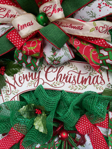 Close Up of Merry Christmas Banner Sign with Painted Mistletoe Branches on it. 