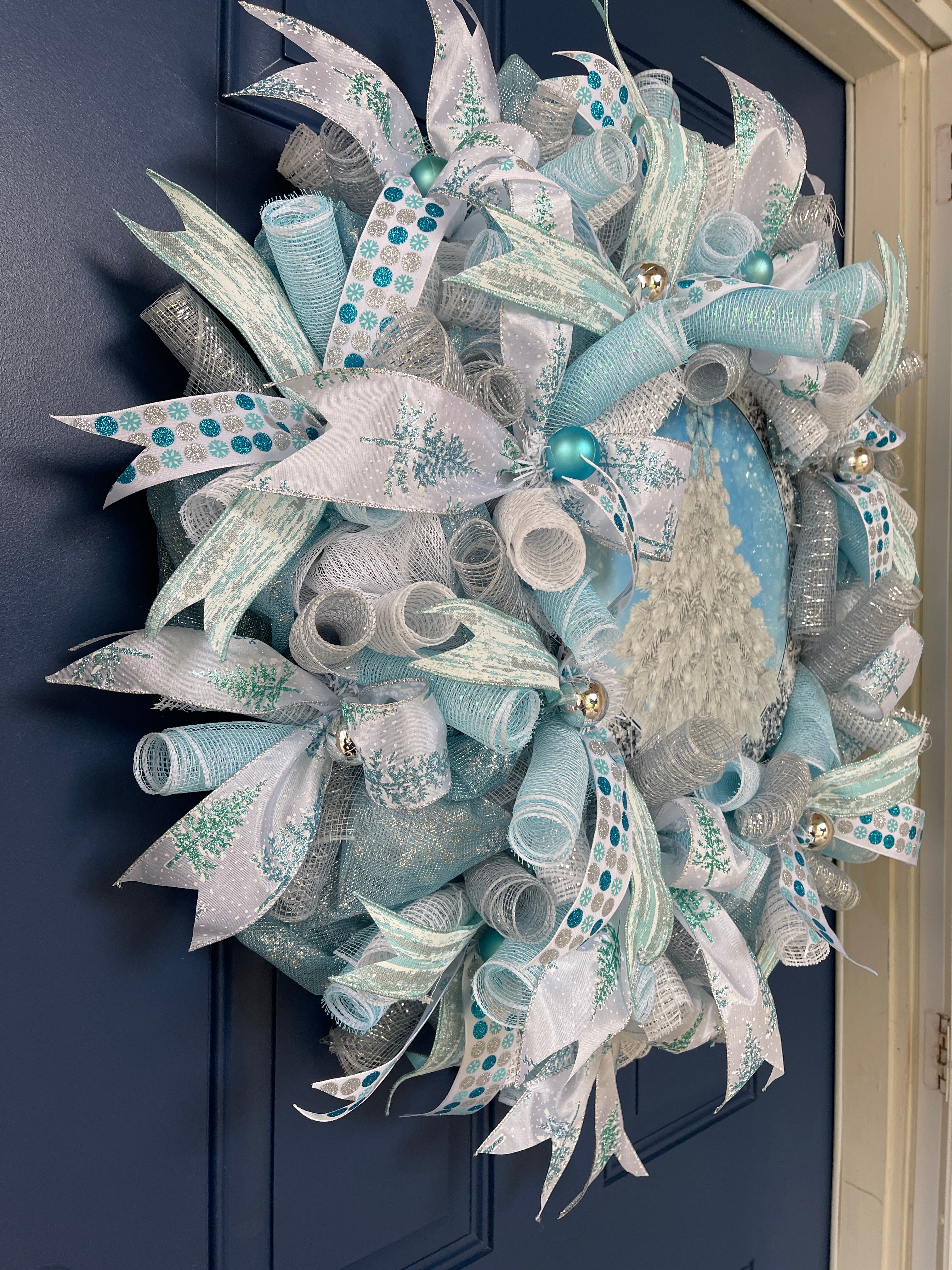 Left Side View of Blue and White Deco Mesh Winter Christmas Tree Wreath on a Blue Door 