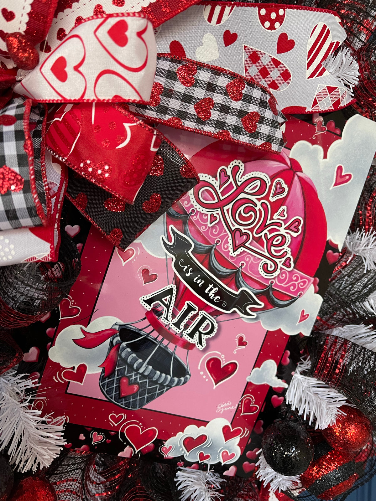 Close up of Love is in the Air Sign Hot Air Balloon sign with hearts