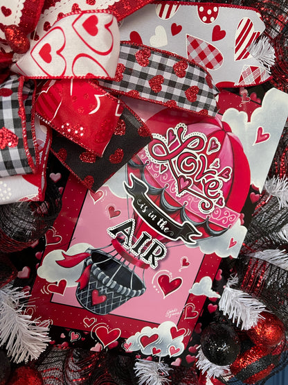 Close up of Love is in the Air Sign Hot Air Balloon sign with hearts