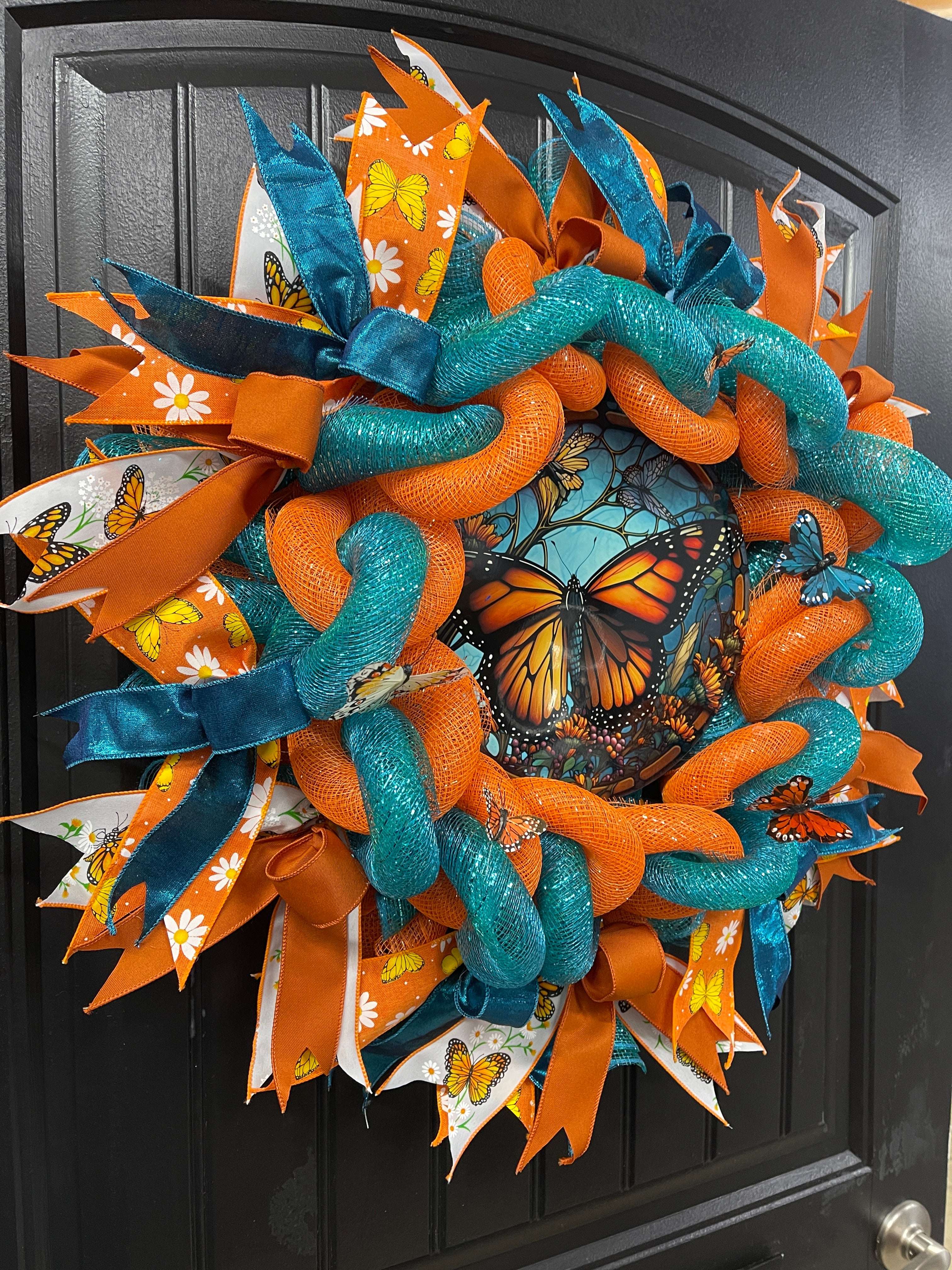 Left Side View on Teal and Orange Woven Monarch Butterfly Deco Mesh Spring Wreath on Black Door
