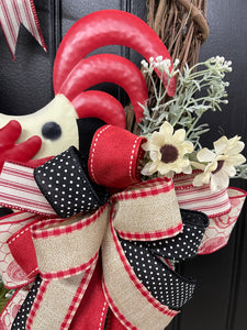 Close Up Detail of Lower Bow featuring Black, Red, White and Tan Ribbons featuring Polka Dot, Gingham and Ticking Print along with Artificial White Sunflowers on a Grapevine Wreath