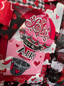 Close up of Love is in the Air Sign Hot Air Balloon sign with hearts