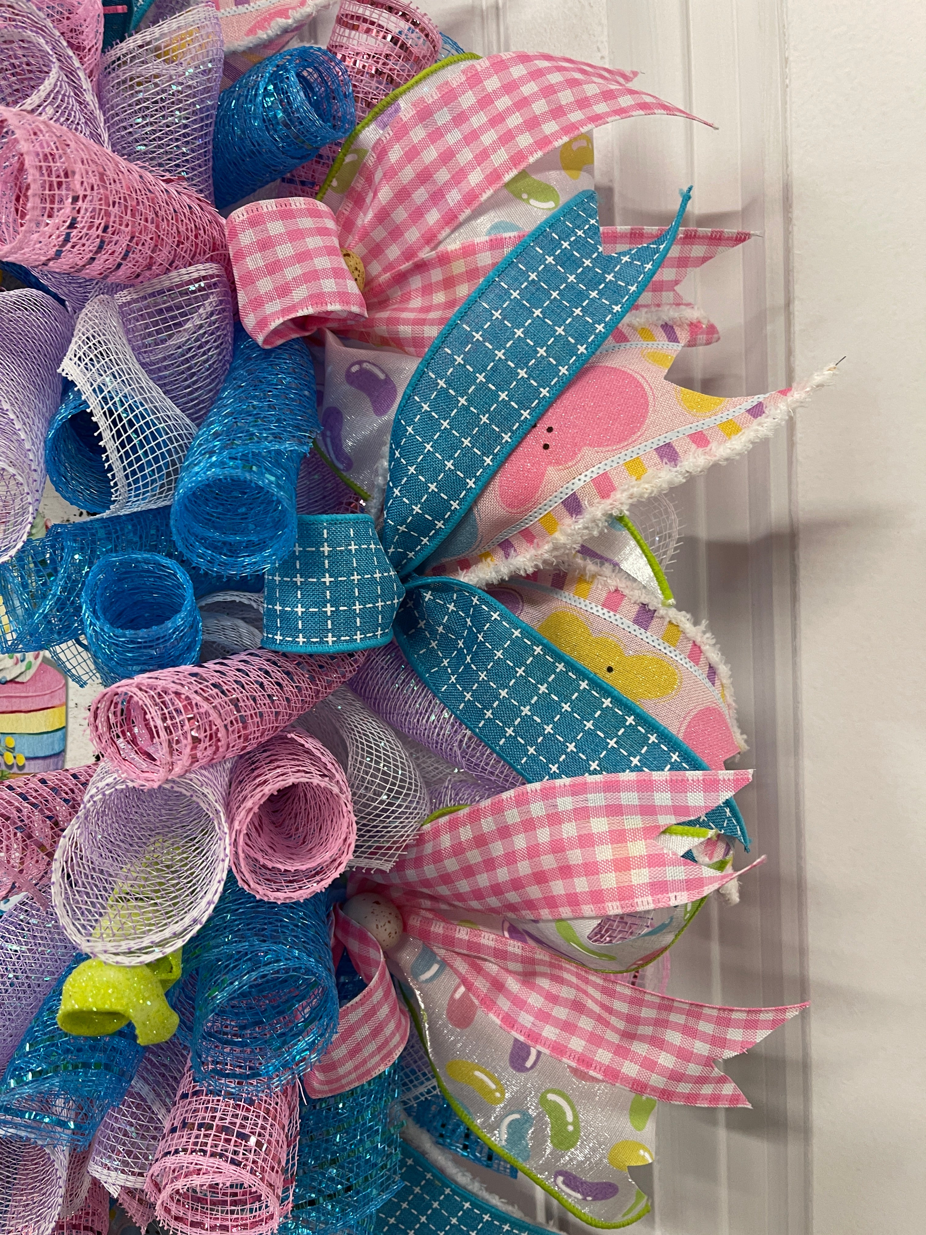 Close up on pastel Deco Mesh Curls of Pink, Blue, White and Purple on a Wreath