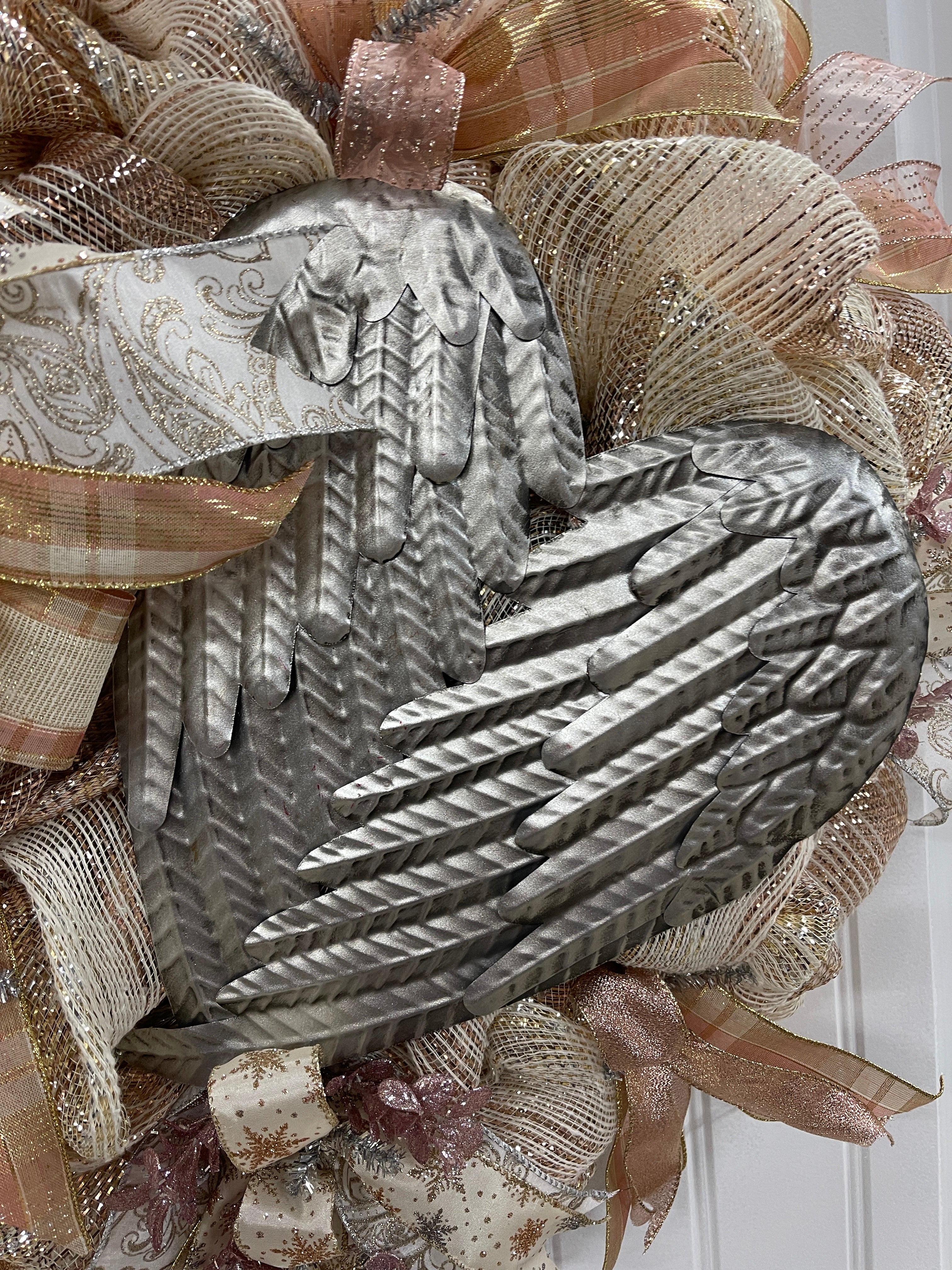 Close up on Antique Silver Folded Angel Wings on Wreath