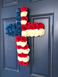 Right Side View of Red, White and Blue Roses in the shape of a cross on a blue door