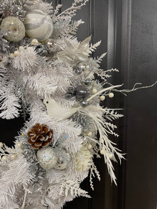 Close Up Detail of White Dove, Silver, Gray and White Christmas Balls on a White Evergreen Wreath