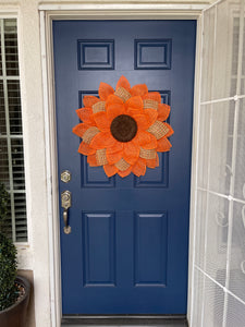 Poly Burlap Mesh Sunflower Wreath Featuring Orange and Patterned Colors of Yellow, Brown and Orange with a Brown Center on a Blue Door 