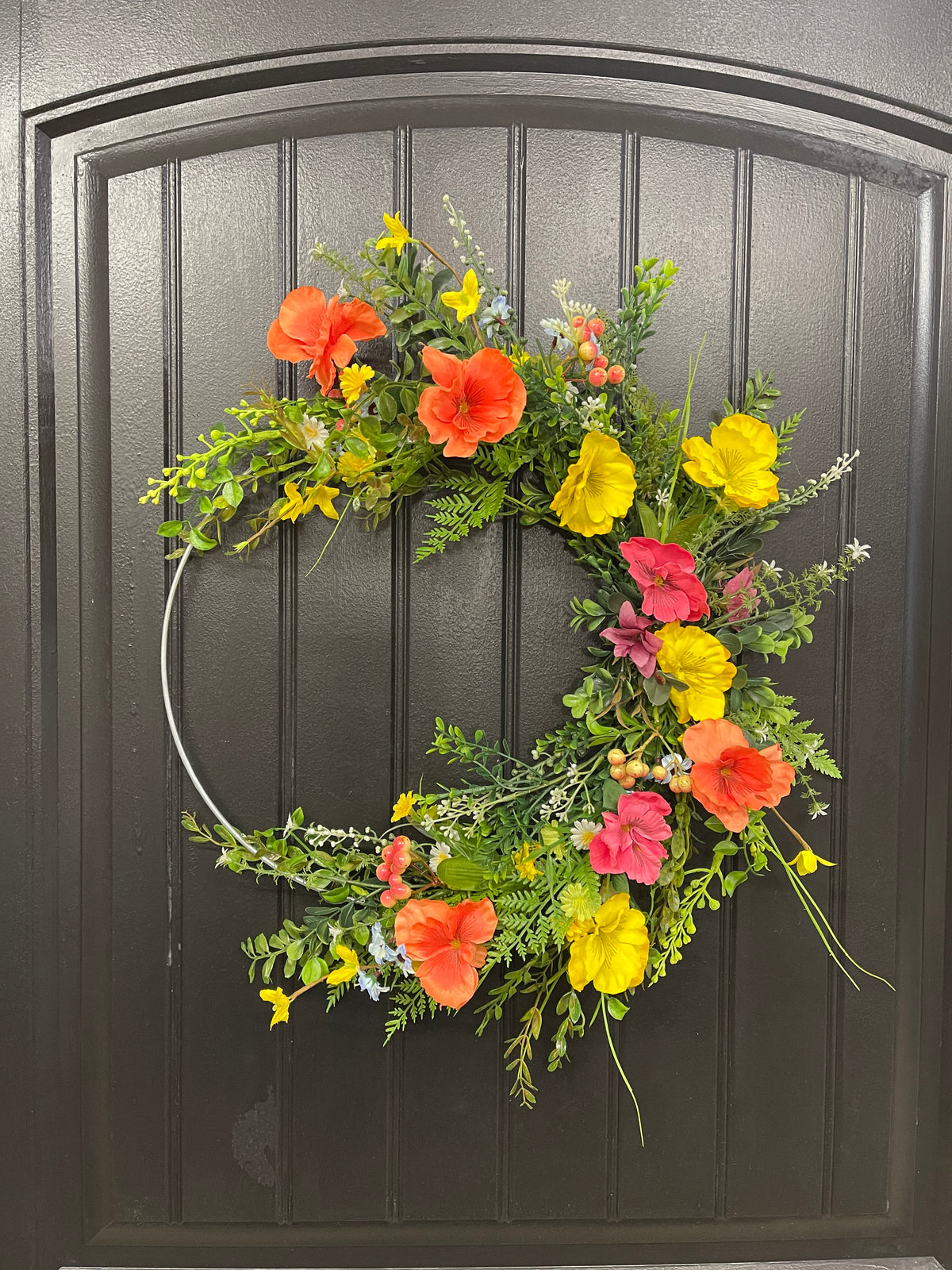 Orange, Pink and Yellow Cosmos Florals with Meadow Greens on a Silver Hoop Wreath on a Black Door