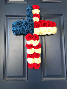 Bottom View of Red, White and Blue Roses in the shape of a cross on a blue door
