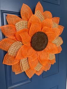 Left Side View of Poly Burlap Mesh Sunflower Wreath Featuring Orange and Patterned Colors of Yellow, Brown and Orange with a Brown Center on a Blue Door
